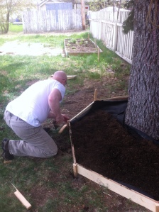The dear one finishing up the edging after we have all the new soil mixture in. 